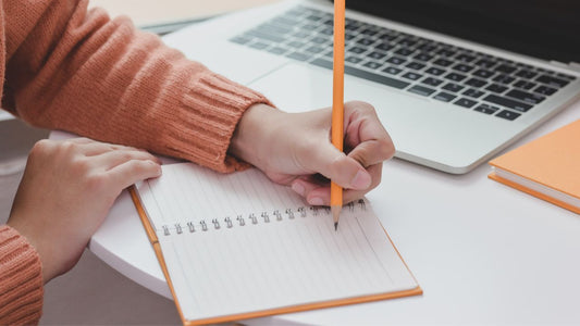Person writing in a Notebook