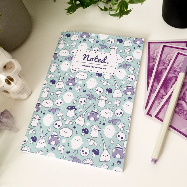 Notebook with spooky yet adorable Halloween-themed illustrations on the cover.
