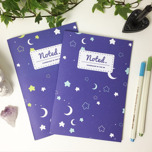 Notebook with moons and stars on the cover design.