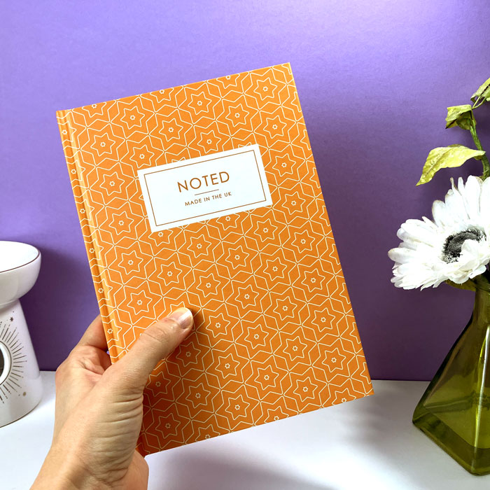 Custom A5 journal with geometric star design on hardcover.