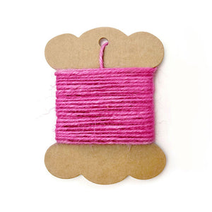 Bright pink natural fiber string for crafting and wrapping.