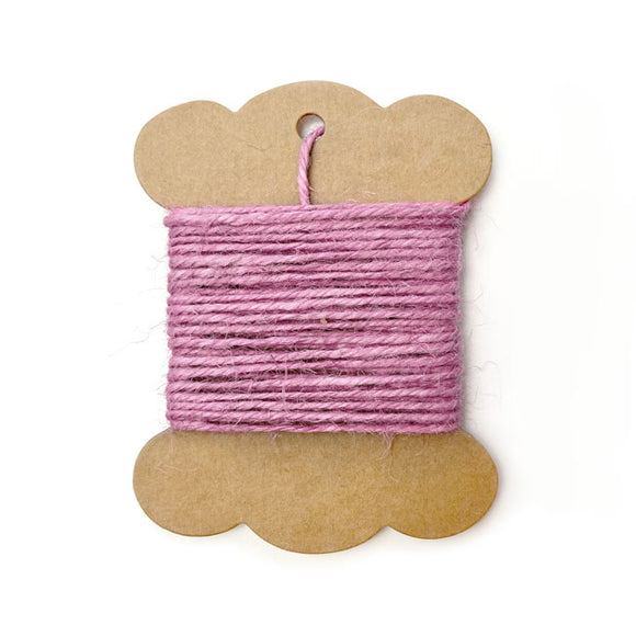 Roll of baby pink jute twine for crafts and packaging.