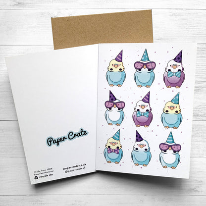 Colorful birthday card featuring budgies wearing tiny hats and bows.