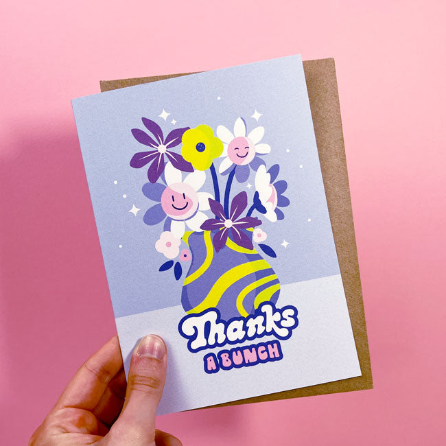 Hand holding a greeting card with the words Thanks a Bunch