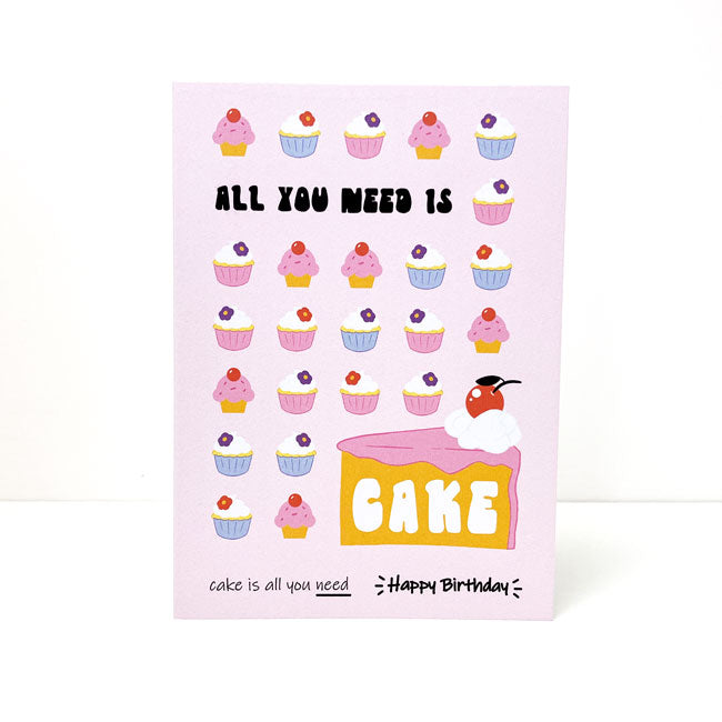 Illustrated birthday card with the phrase "All You Need Is Cake."
