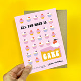 Illustrated birthday card with the phrase "All You Need Is Cake."