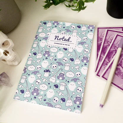 Notebook with spooky yet adorable Halloween-themed illustrations on the cover.