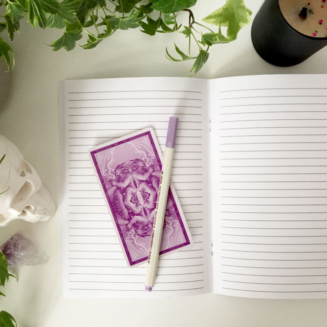 Notebook with celestial pattern of moons and stars on the cover.