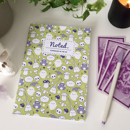 Notebook with spooky yet adorable Halloween-themed illustrations on the cover.