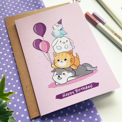 Illustrated pink birthday card featuring adorable animals celebrating.
