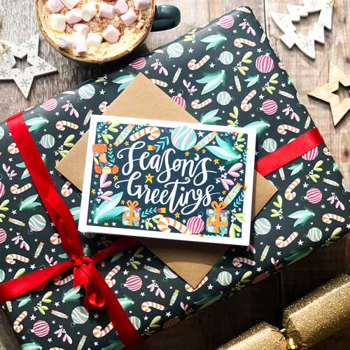 Holiday card with festive design and "Season's Greetings" message.