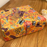 Illustrated eco-friendly wrapping paper with bunnies and butterflies design.