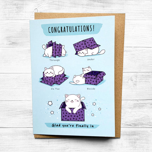 Humorous greeting card featuring a cat popping out of a box.