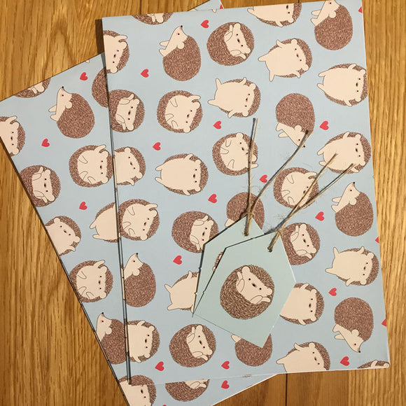Recyclable wrapping paper featuring hedgehogs and hearts, with tags included.