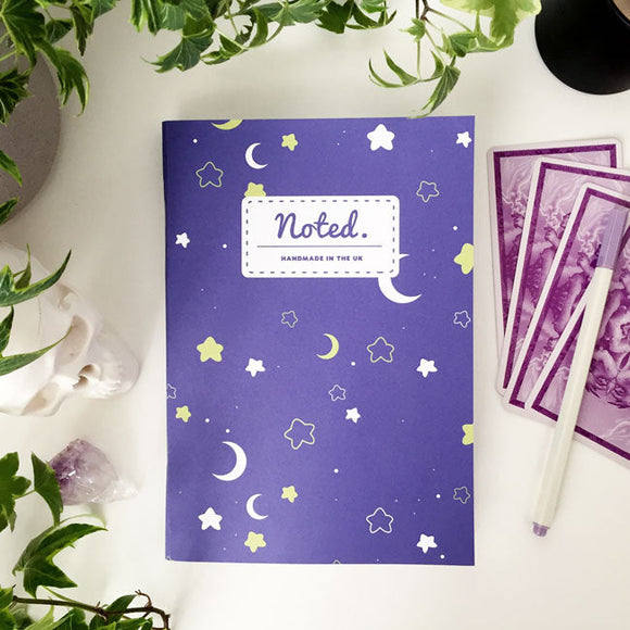 Notebook with moon and star design on cover.