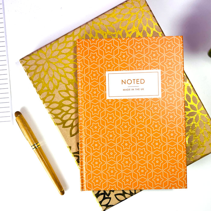 Custom A5 hardcover notebook with a geometric star design on the cover.