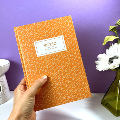 Custom A5 journal with geometric star design on hardcover.