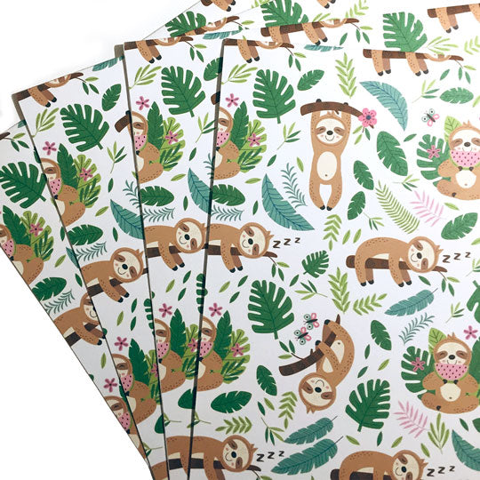 Colorful wrapping paper with jungle theme and sloth illustrations.