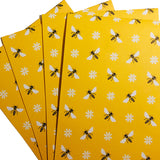 Eco-friendly wrapping paper with bee patterns, suitable for sustainable gift-giving.