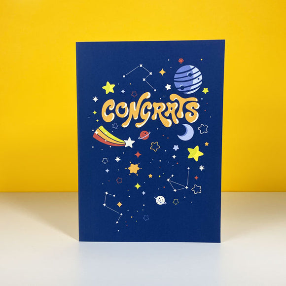 Greeting card with space-themed congratulations design.