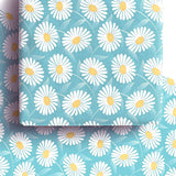 Eco-friendly wrapping paper with daisy print, suitable for sustainable gift-giving.