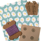 Eco-friendly wrapping paper with daisy patterns, includes tags and string.