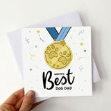 Card featuring medal design with "World's Best Dog Dad" inscription.
