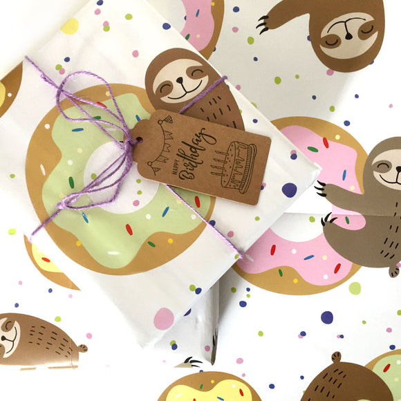 Sloth-themed wrapping paper with colorful doughnut patterns.