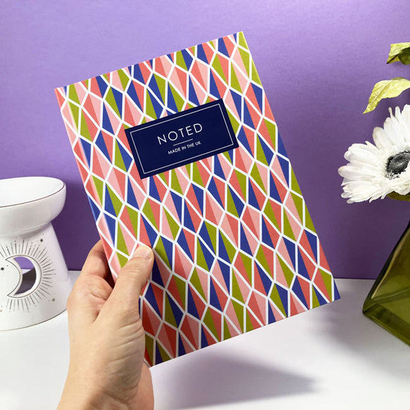 Custom A5 notebook with a colorful, geometric kite-shaped pattern on cover.