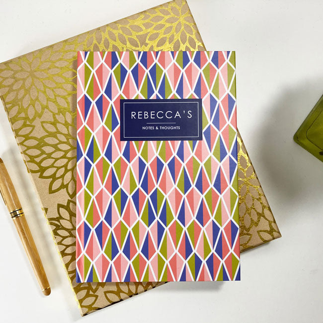 Custom A5 notebook with a colorful, geometric kite-shaped pattern on cover.