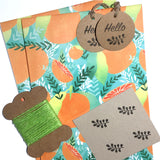 Vibrant orange-themed, eco-friendly gift wrap with tropical patterns.