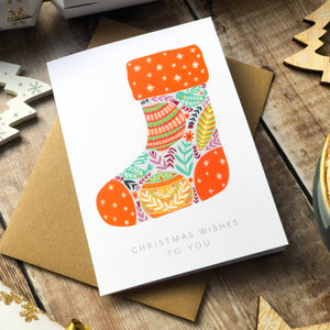 Christmas-themed greeting card shaped like a festive stocking.