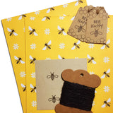 Eco-friendly wrapping paper with bee patterns, suitable for sustainable gift-giving.