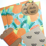 Vibrant orange-themed, eco-friendly gift wrap with tropical patterns.