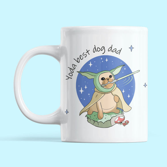 Yoda best dog dad mug positioned against a pastel blue background. Featuring a pug, wielding a lightsabre in his mouth.