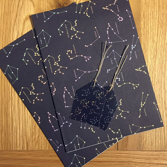 Recyclable wrapping paper with constellation design and matching tags.