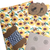 Eco-friendly wrapping paper with bee and sunflower print design.