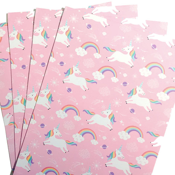 Colorful wrapping paper with unicorns and rainbows design.