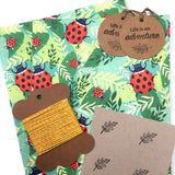 Eco-friendly wrapping paper with ladybird patterns, includes tags and string.
